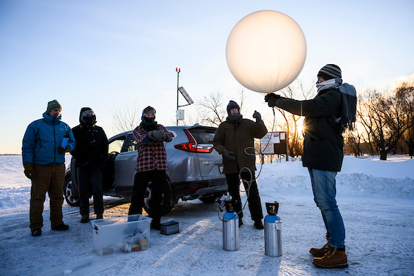 Professor Grant Petty and students launching a weather balloon.